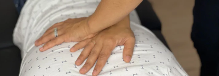 A patient receiving a back adjustment