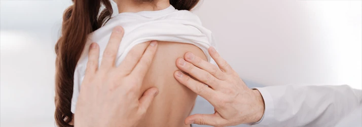 A pediatric patient receiving a chiropractic exam