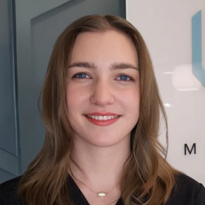 A headshot photo of Coady, a community outreach coordinator at Thrive Integrative Health