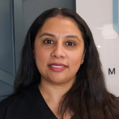 A headshot photo of Indra, a patient care coordinator at Thrive Integrative Health