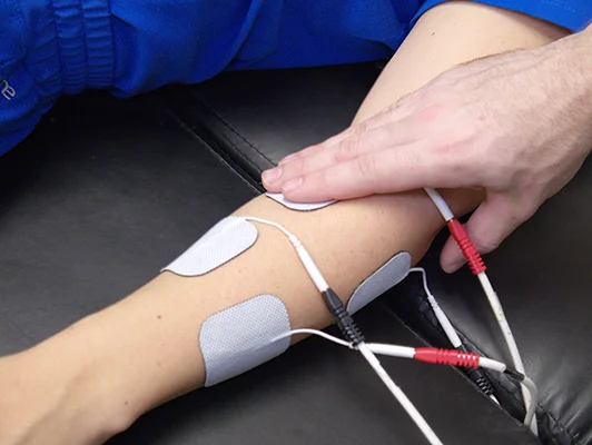 A practitioner applying EMS nodules to a patient's arm