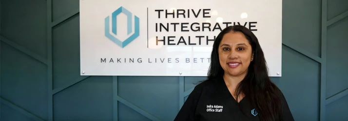A smiling receptionist at the front desk