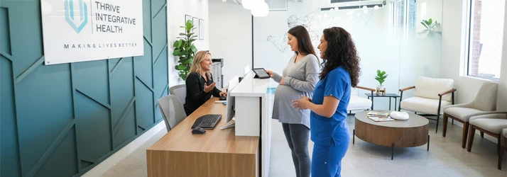 Dr. Christina Wellner and a pregnant patient at the front desk