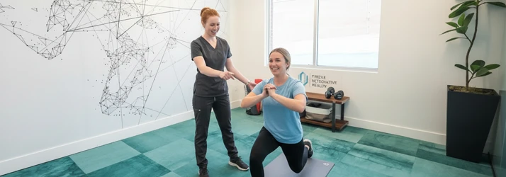 Rehab specialist Ryan guiding a patient through rehab exercises